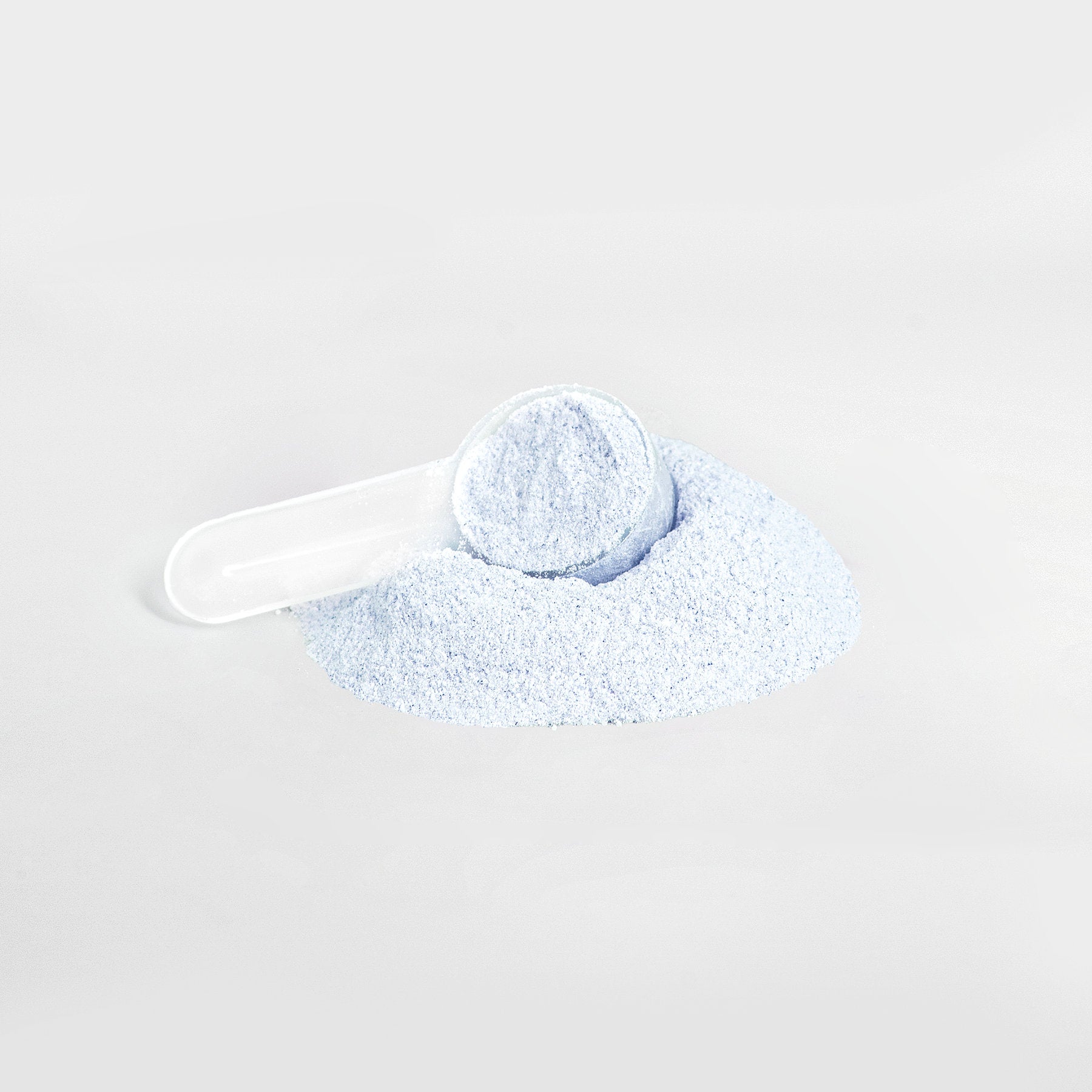 Cotton candy energy powder scoop on a white background.